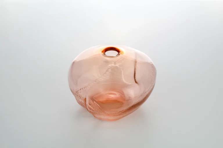 1 2 Ltr Forms Aurora Yellowish Handmade Glass Object by Vogel Studio seen from the side, showing a dented surface