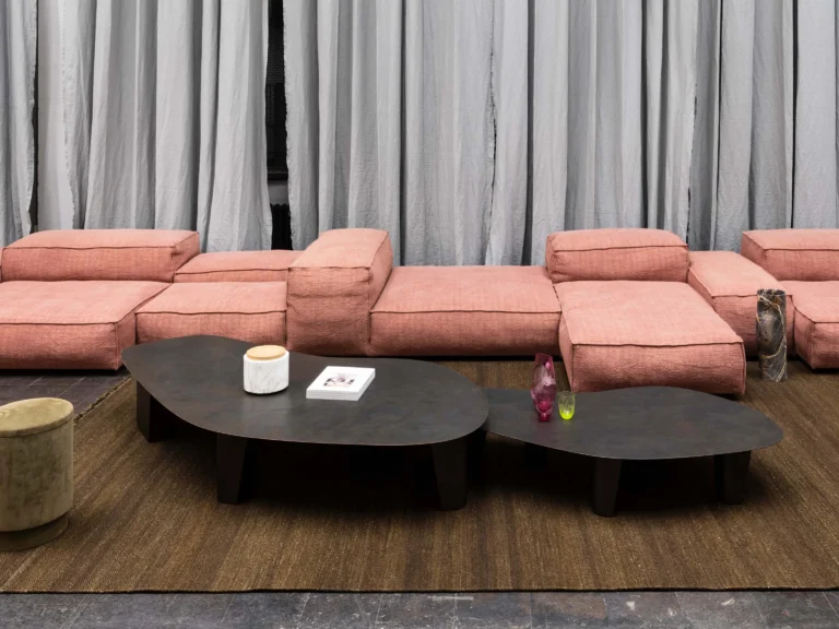 Paris Coffee Table by Vogel Studio as two tables of different sizes in front of a coral sofa and grey curtains