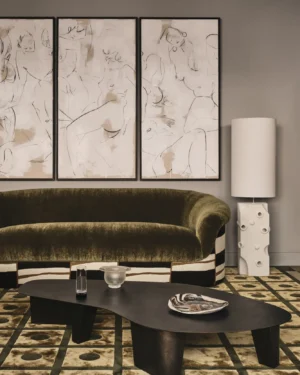 Paris Coffee Table by Vogel Studio, blackened steel, in front of an olive velvet sofa and a rug with a square grid