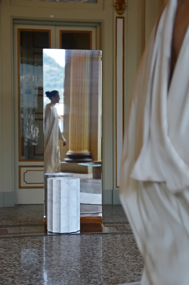 Meditations - Full-Length Mirror by STUDIO VON SCHOENEBECK in a historic hall, a woman in white reflected in the steel