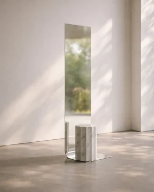 Meditations - Full-Length Mirror by STUDIO VON SCHOENEBECK, steel mirror with a fluted marble column, in a sunlit empty room