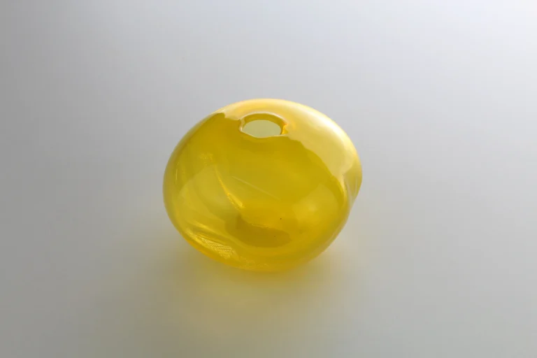 1 2 Ltr Forms by Vogel Studio seen from above, translucent yellow glass with its small round opening at the top
