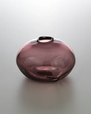 1 2 Ltr Forms by Vogel Studio, wine red blown glass object with a small opening, on a plain background