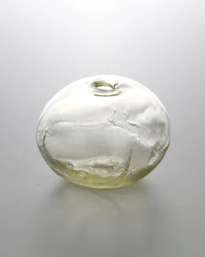 1 2 Ltr Forms by Vogel Studio, light yellow blown glass object with a small opening, on a plain background
