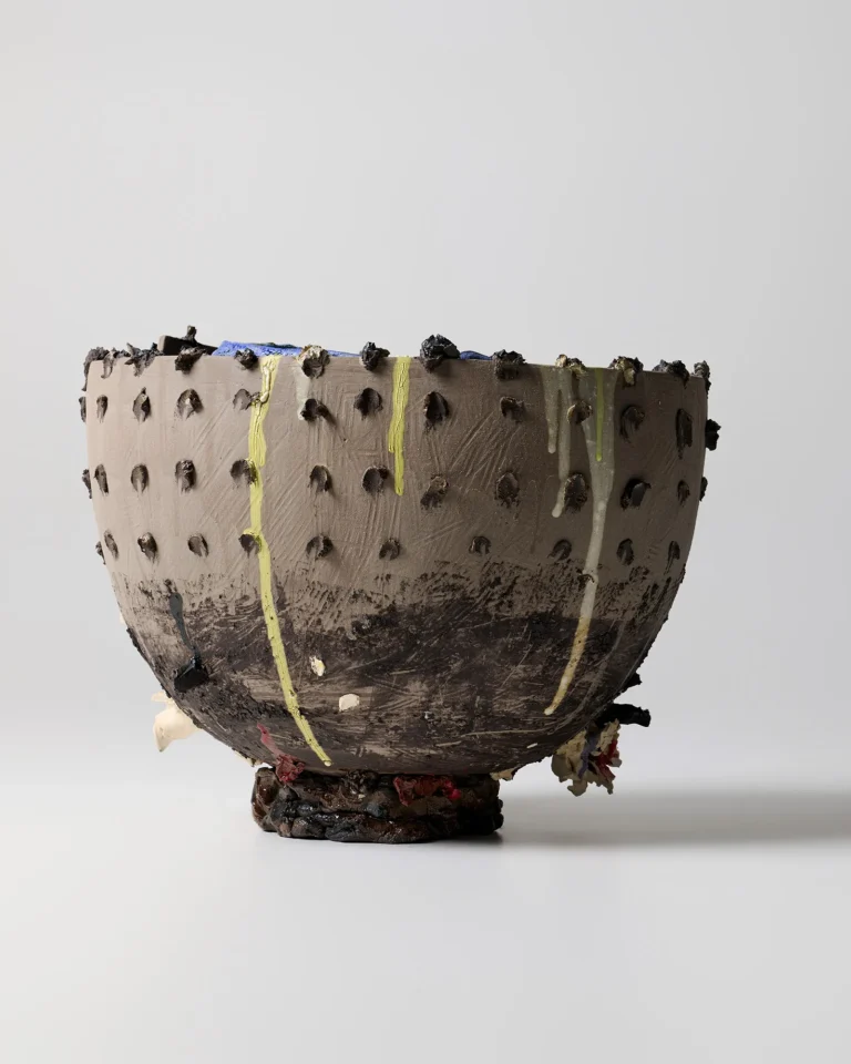 New_love_08 Ceramic Vase by C E R A M I C 4 7 seen from a lower side angle, yellow glaze drips running down the dotted wall