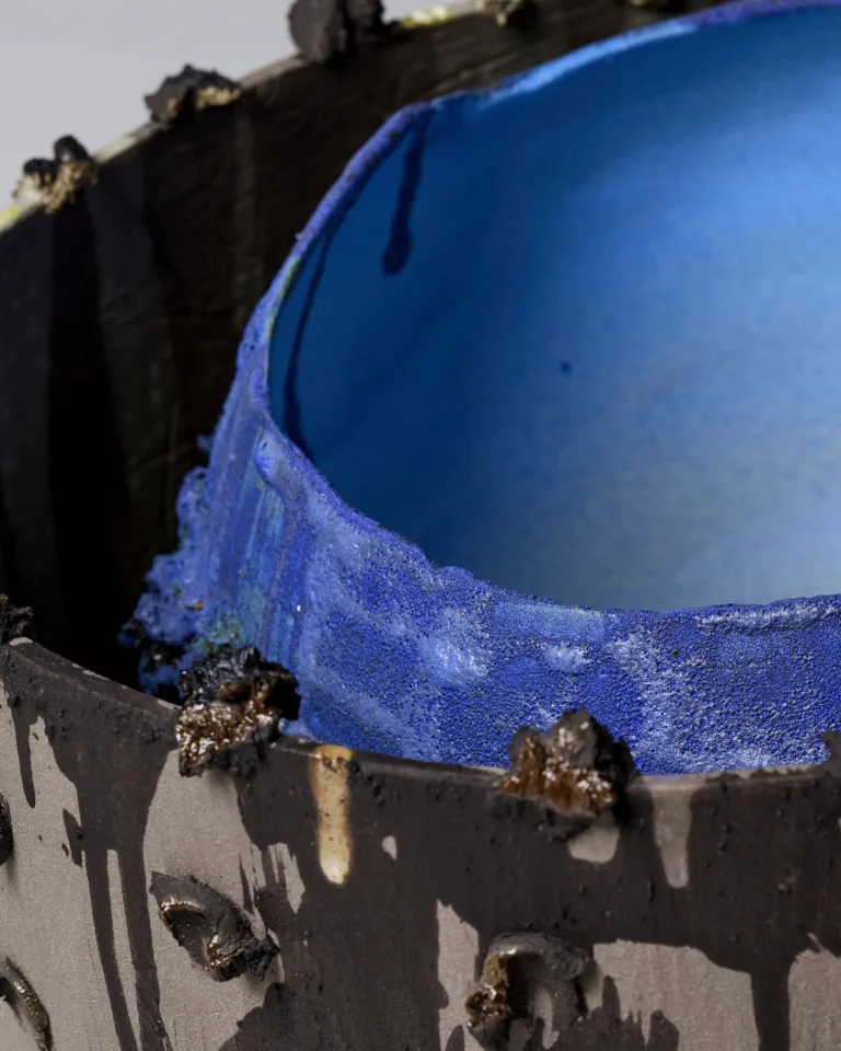 Close-up of the New_love_08 Ceramic Vase's cobalt blue inner rim beside the dark outer wall with glaze drips