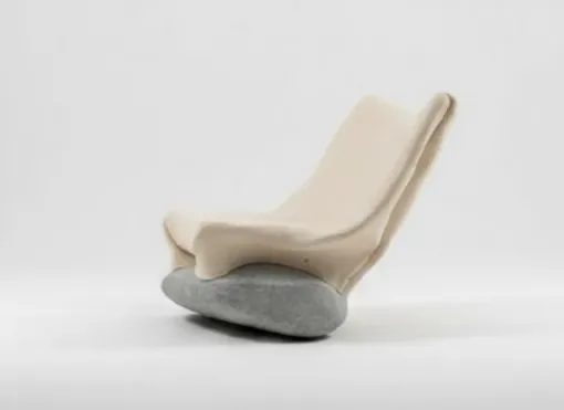 85kg Rocking Chair by Danik Uderbekov, beige felted wool chair resting on a grey stone, on a plain background